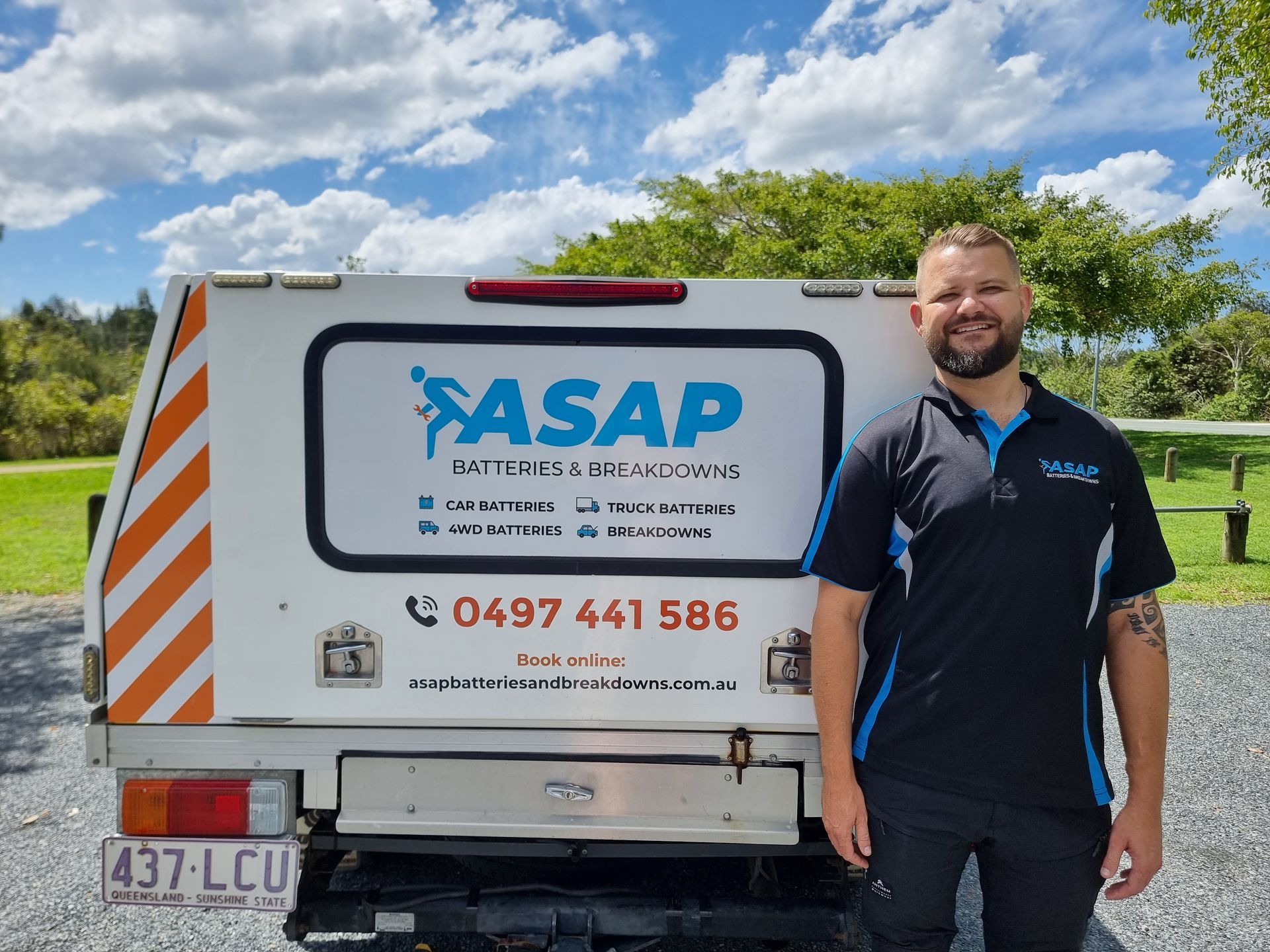 A Man Smiles Next to a White Service Vehicle — ASAP Batteries & Breakdowns in Helensvale, QLD
