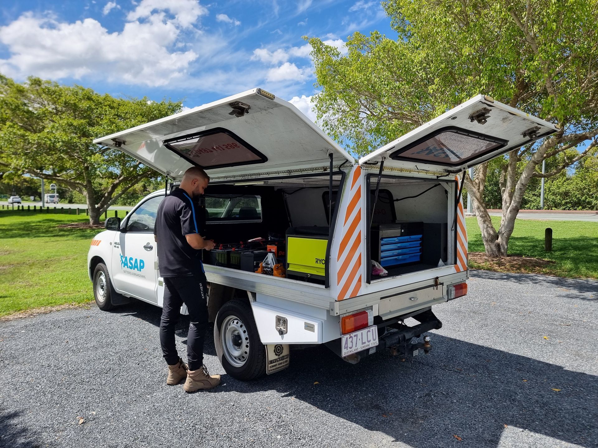 Man Working From Utility Truck With Open Canopy — ASAP Batteries & Breakdowns in Helensvale, QLD