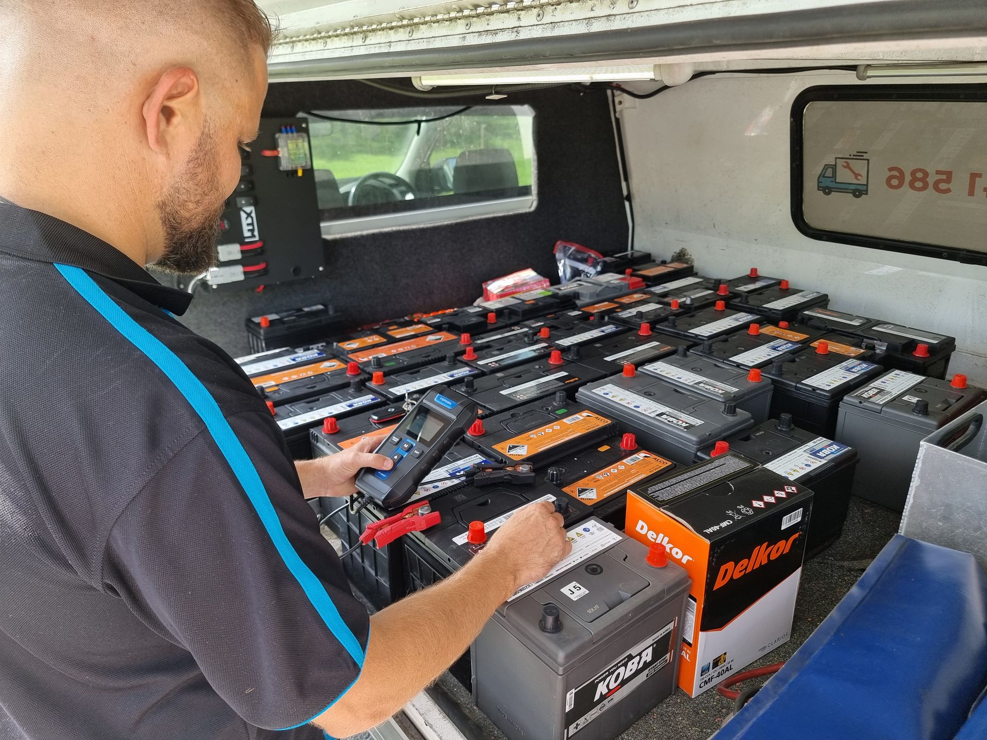 Man Testing Car Batteries in a Van. Many Batteries — ASAP Batteries & Breakdowns in Helensvale, QLD