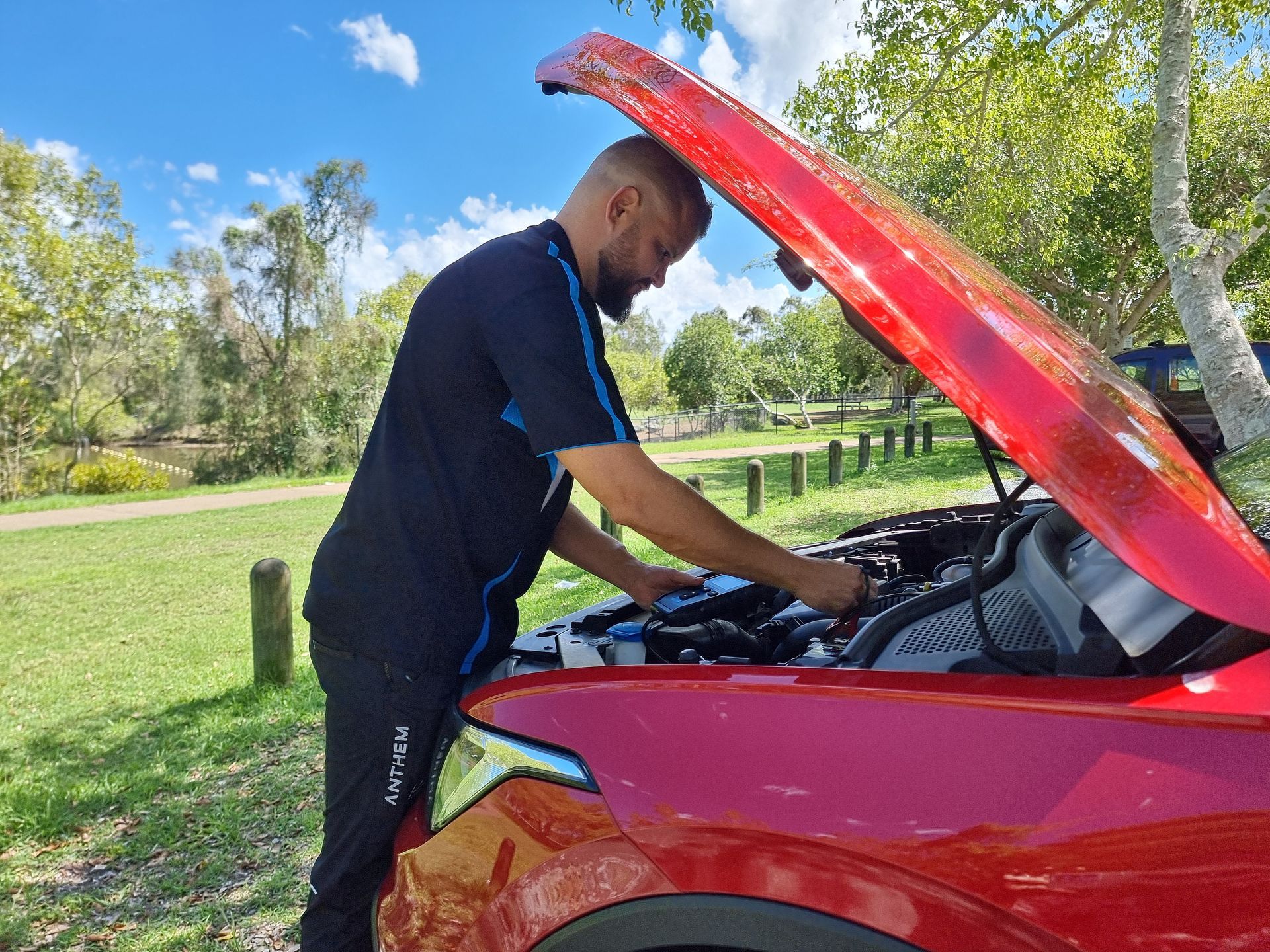 Man in Black Uniform Working on the Engine — ASAP Batteries & Breakdowns in Helensvale, QLD