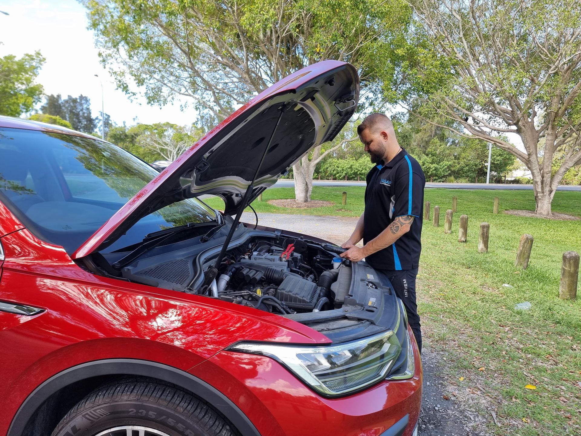 Person in a Black Shirt Checks the Engine — ASAP Batteries & Breakdowns in Helensvale, QLD