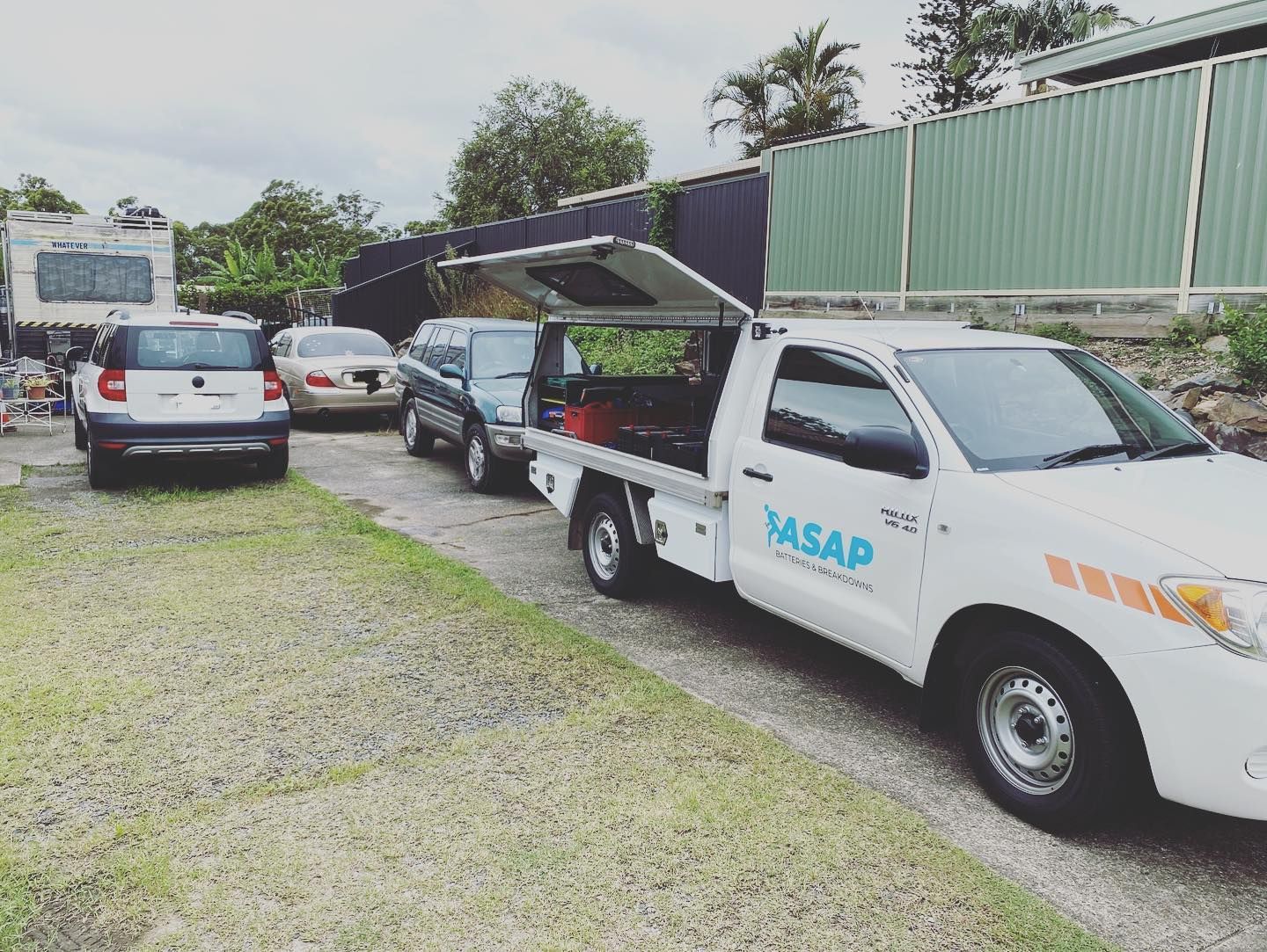 A White Service Truck With an Open Tool Canopy Parked on a Driveway — ASAP Batteries & Breakdowns in Helensvale, QLD