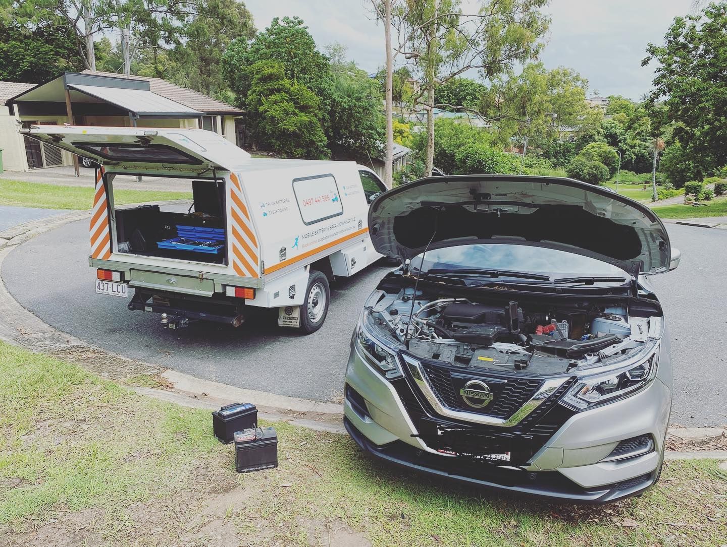A Service Truck is Parked Next to a Silver Nissan With Its Hood Open — ASAP Batteries & Breakdowns in Helensvale, QLD