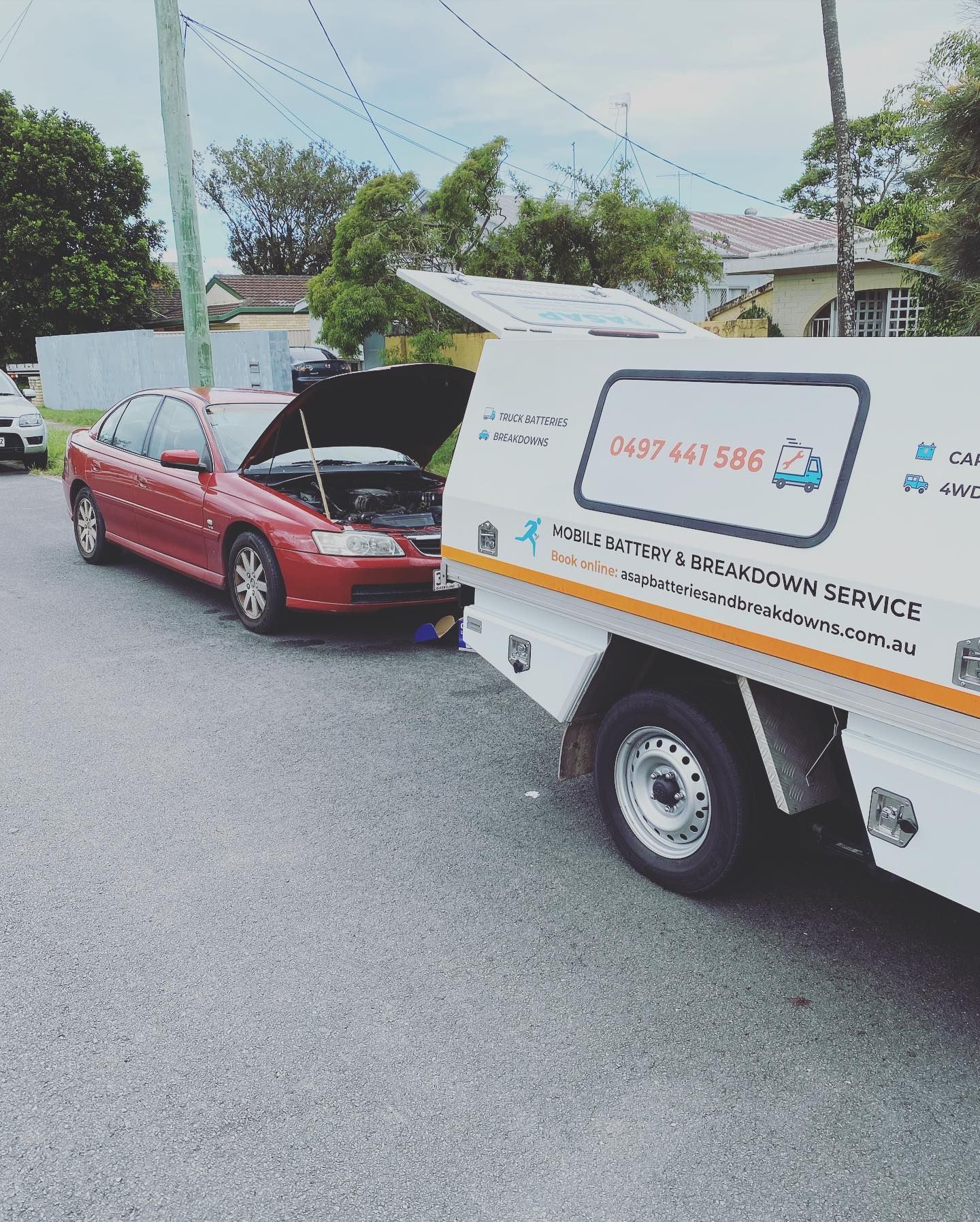 Red Car Being Assist by a White Service Truck — ASAP Batteries & Breakdowns in Helensvale, QLD