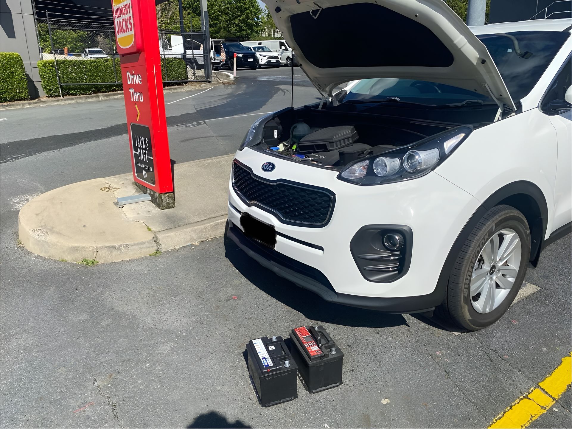 A White Kia With Its Hood Open is Parked in a Drive-thru — ASAP Batteries & Breakdowns in Robina, QLD