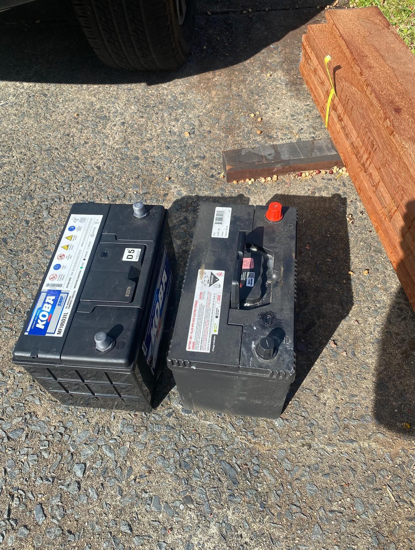Two Automotive Batteries Sit on a Gravel Driveway — ASAP Batteries & Breakdowns in Nerang, QLD