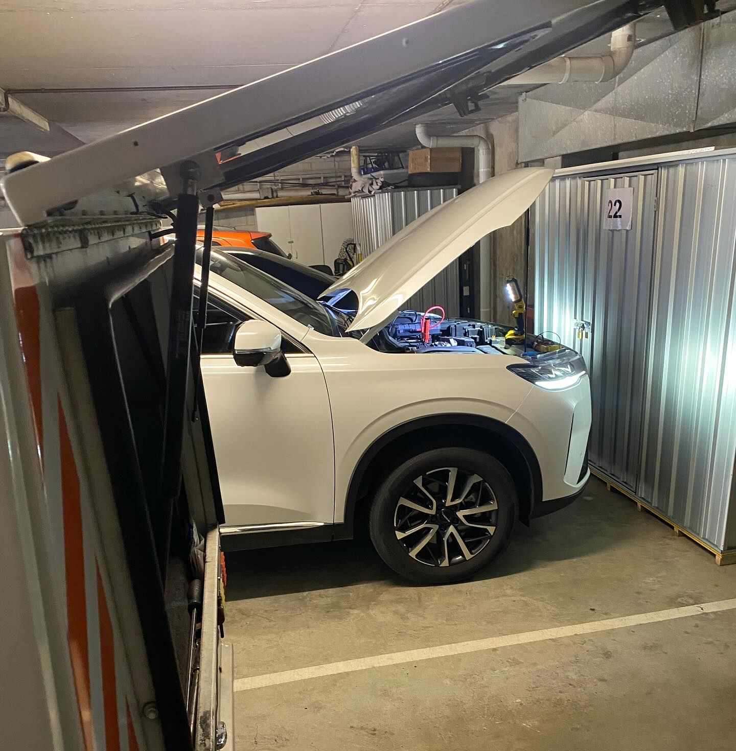 A White SUV With Its Hood Open and a Work Light Inside — ASAP Batteries & Breakdowns in Robina, QLD