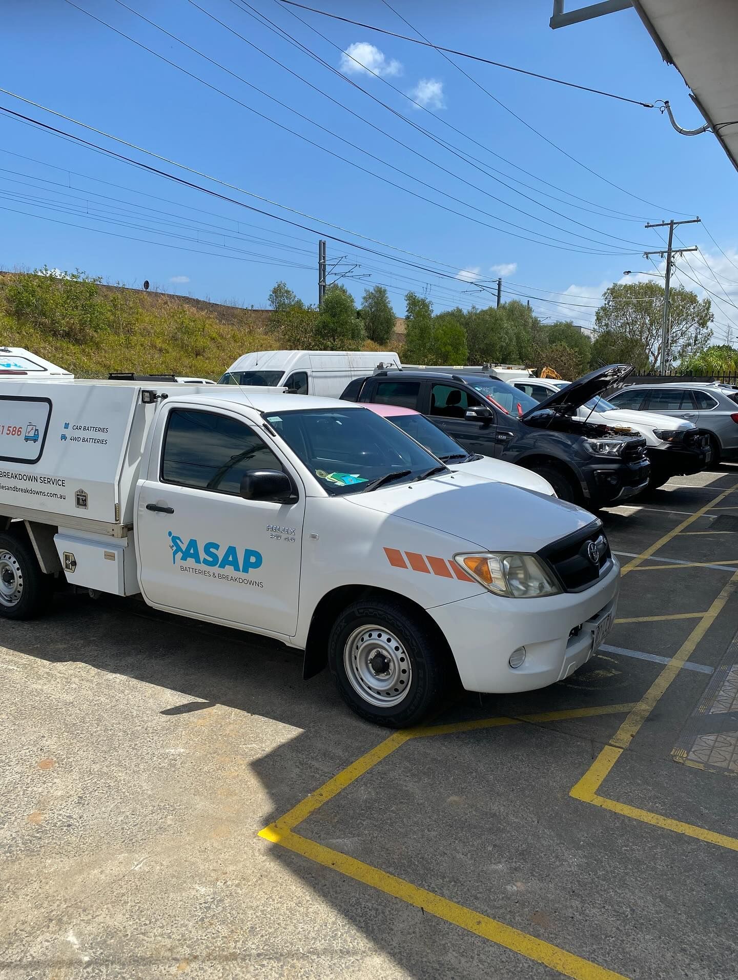 A White ASAP Branded Utility Truck Parked in a Gravel Lot — ASAP Batteries & Breakdowns in Southport, QLD