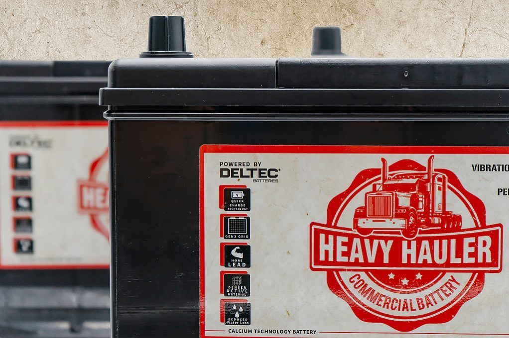 Two Black Commercial Heavy-duty Batteries With White and Red Labels — ASAP Batteries & Breakdowns in Helensvale, QLD