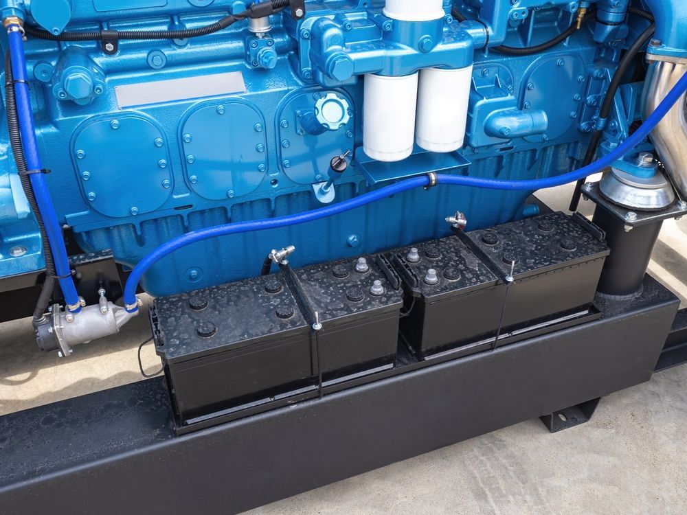 Blue Industrial Engine With Three Black Batteries in a Black Container — ASAP Batteries & Breakdowns in Helensvale, QLD