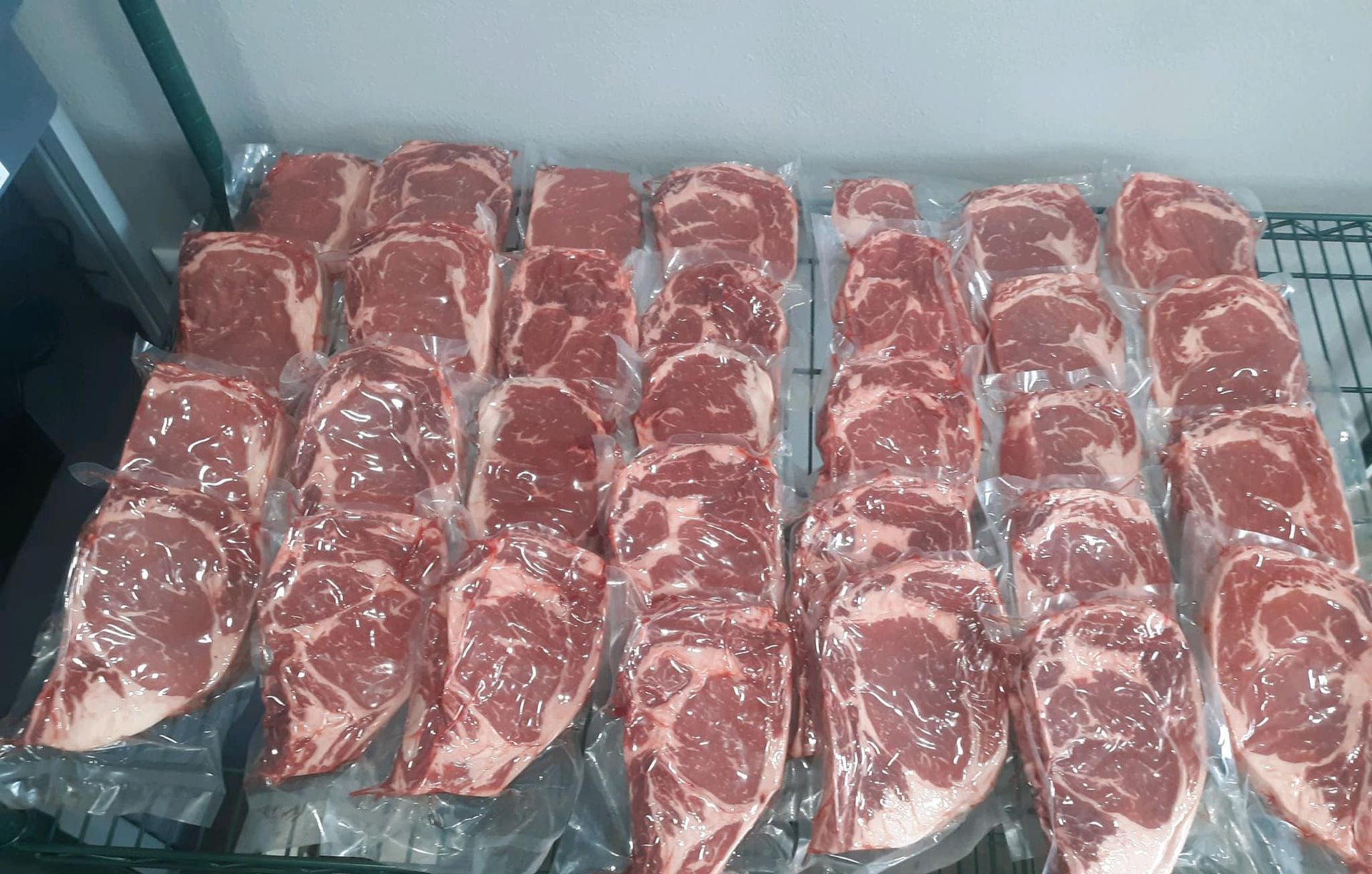 A freezer filled with lots of local processed and butchered meat and vegetables.