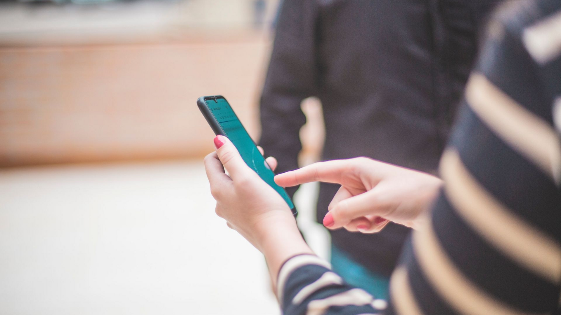 Tenant paying rent online with a smartphone for Kansas City area rental property management