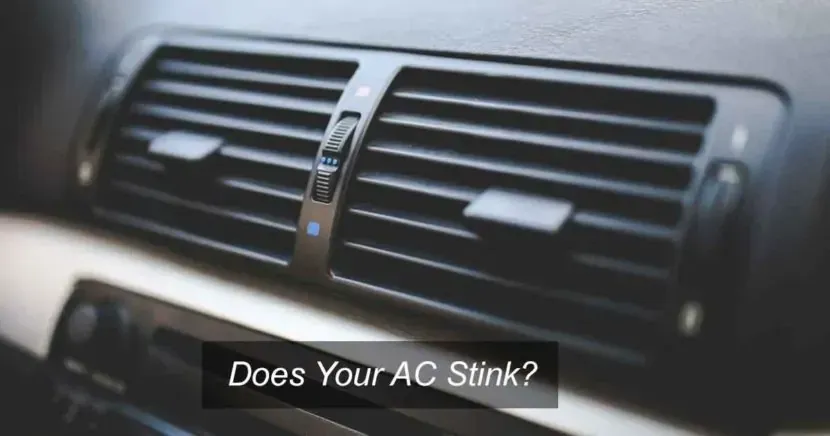 A close up of a car air vent with the words `` does your ac stink '' written above it.