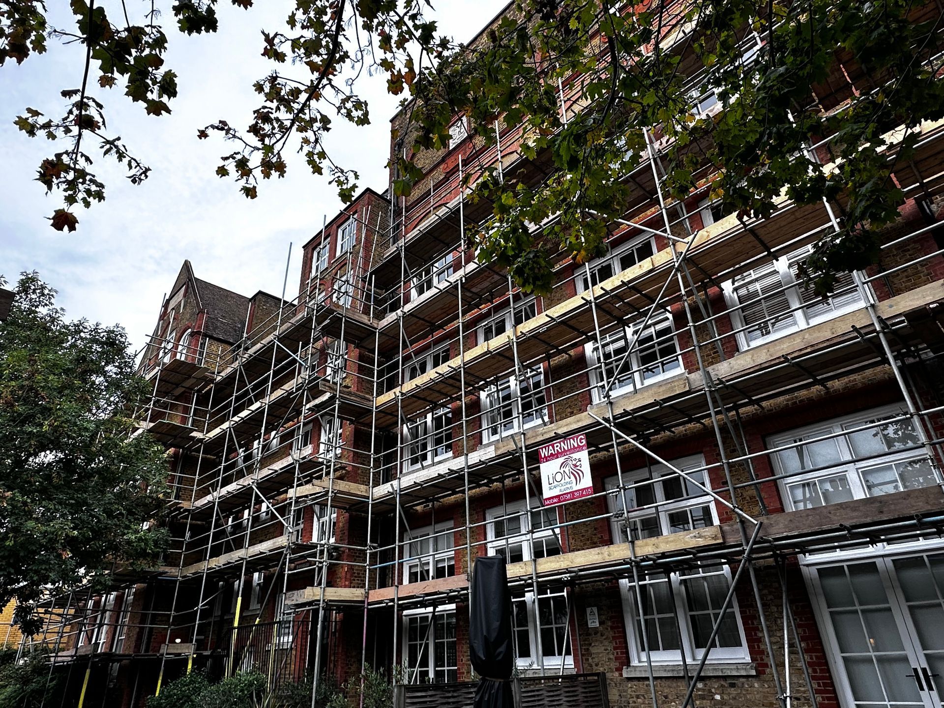 A large brick building with scaffolding around it.