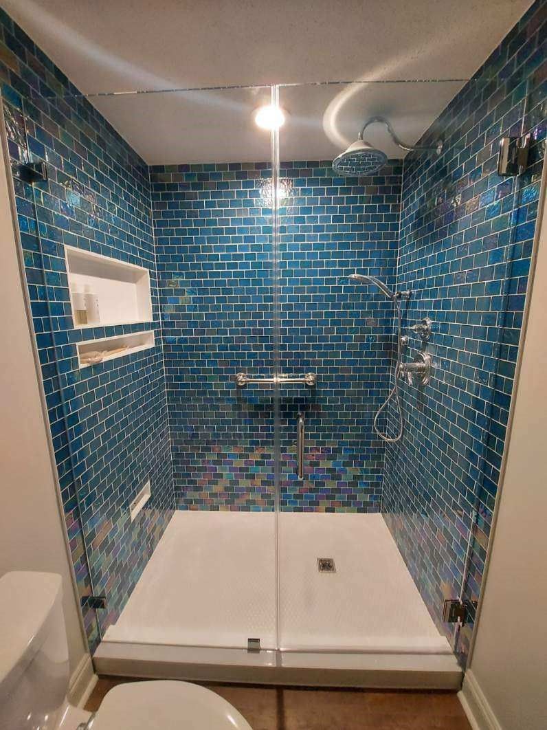 Blue-tiled shower with glass doors