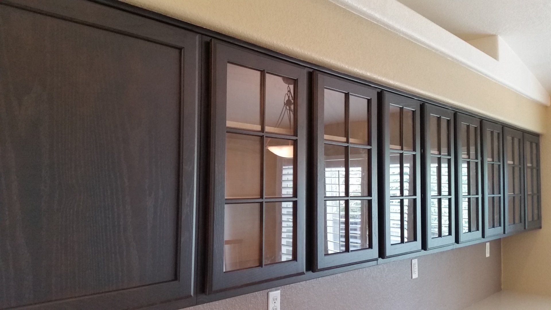 glass front cabinetry finished in espresso