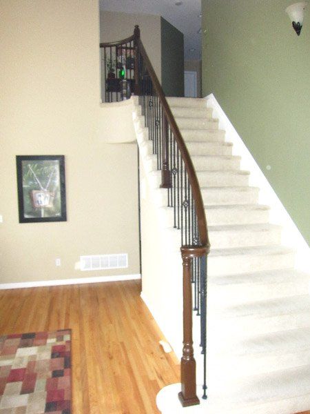 Before picture of black stair railing, unpainted steps