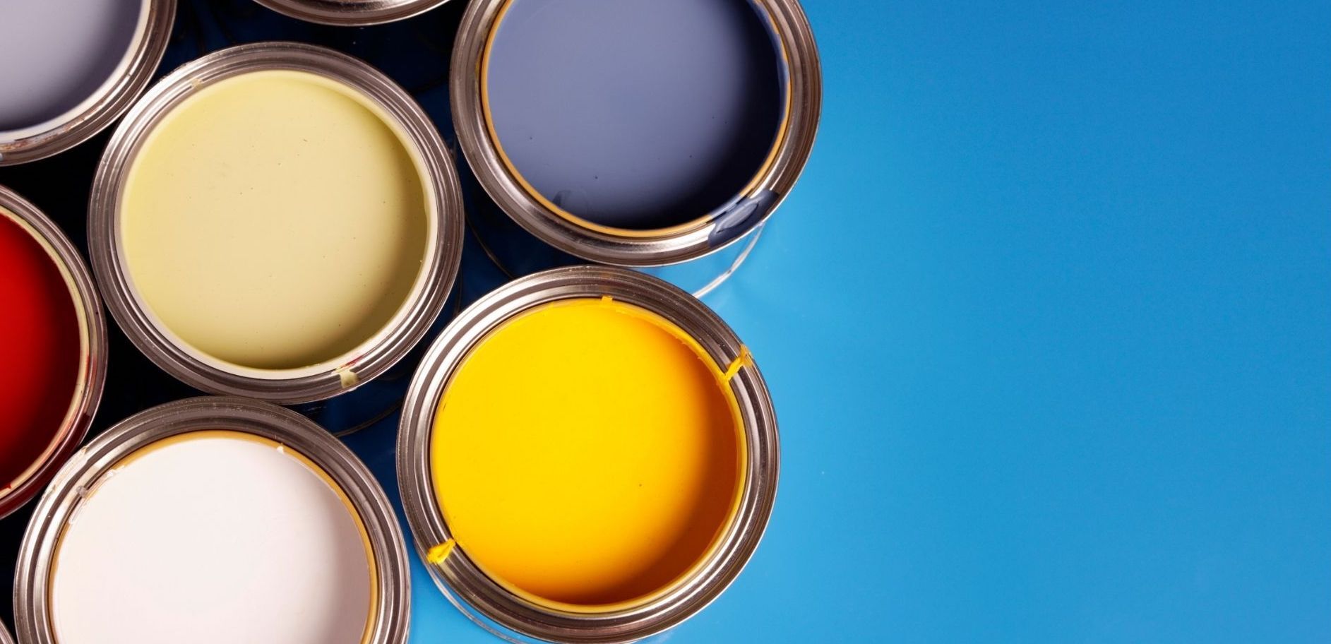 picture of full paint cans with different bright colors