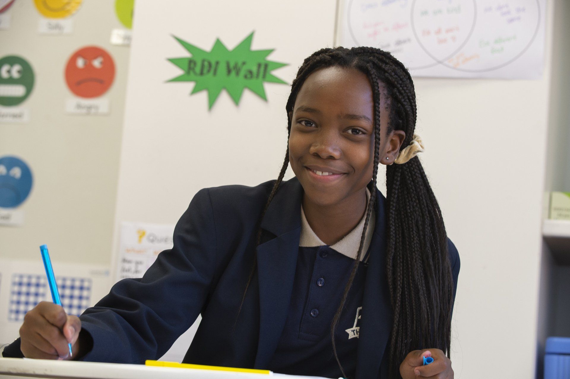 a girl is sitting at a desk