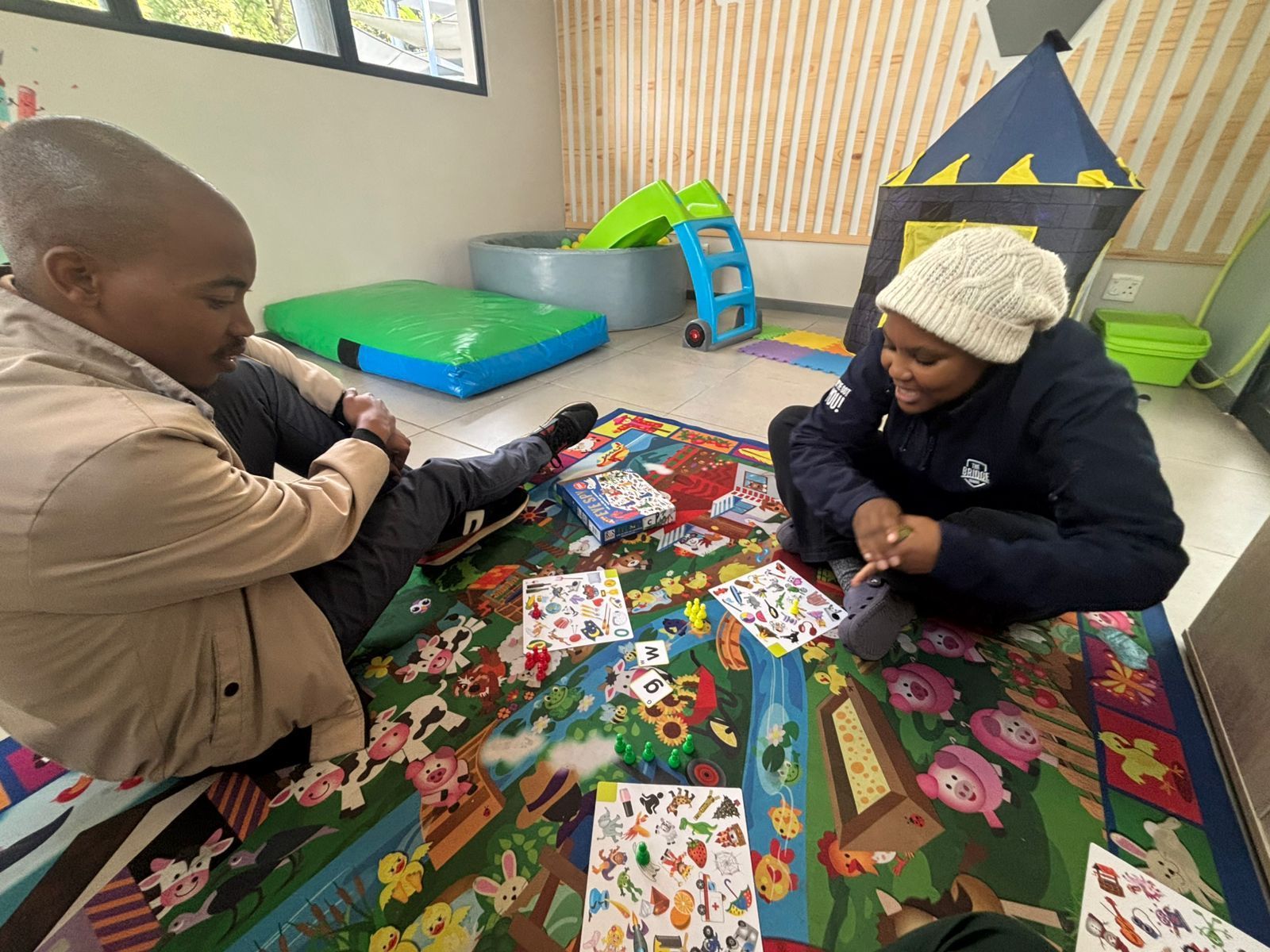 parent helping child with objects
