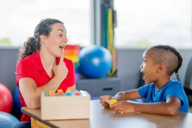 Therapist teaching a child speech
