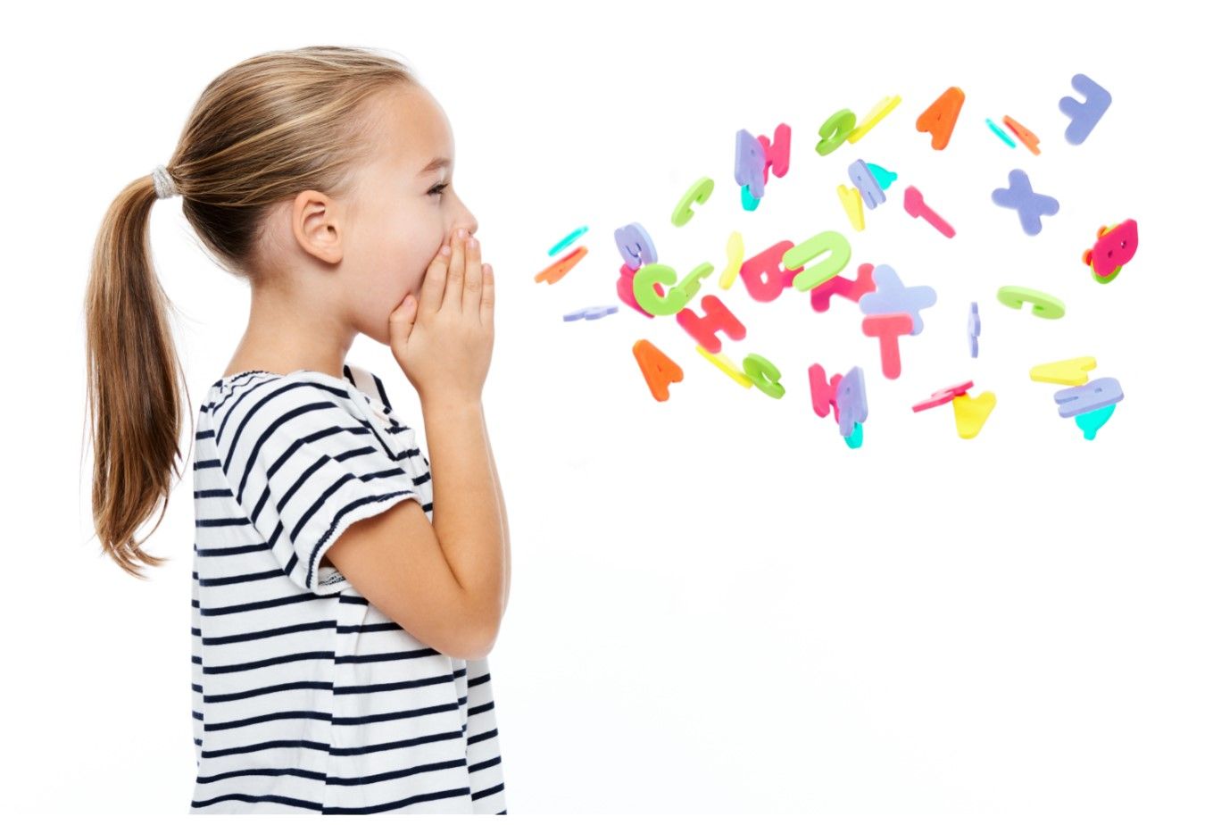A little girl is blowing letters out of her mouth.