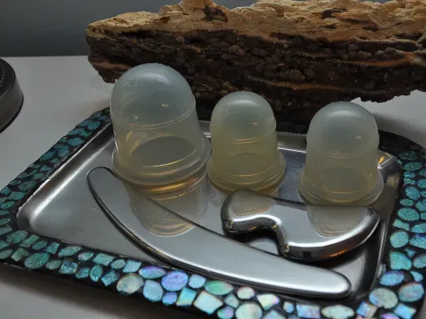 A tray with three cups and a tool on it