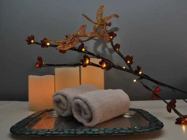 A tray with two towels and candles on it