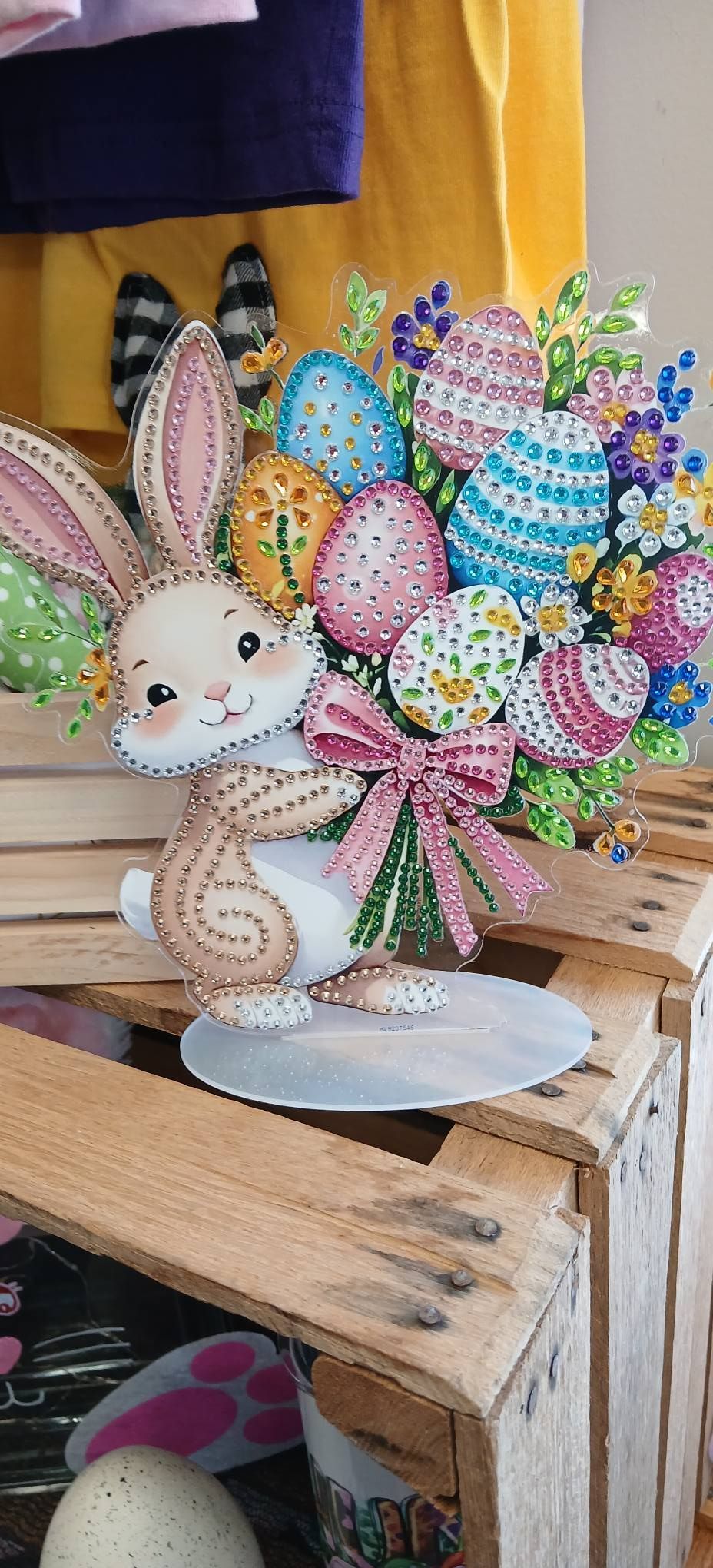 Colorful Easter bunny and egg bouquet centerpiece on a wooden table