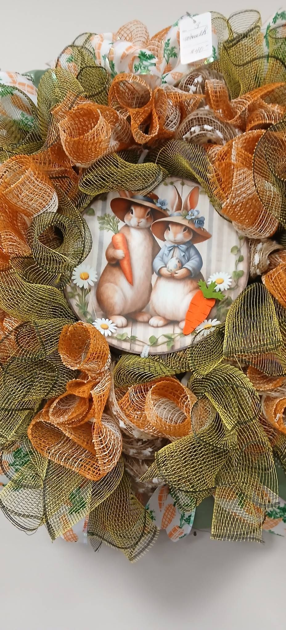 Fall wreath with orange mesh ribbon and a snowy bunny and fox center decoration