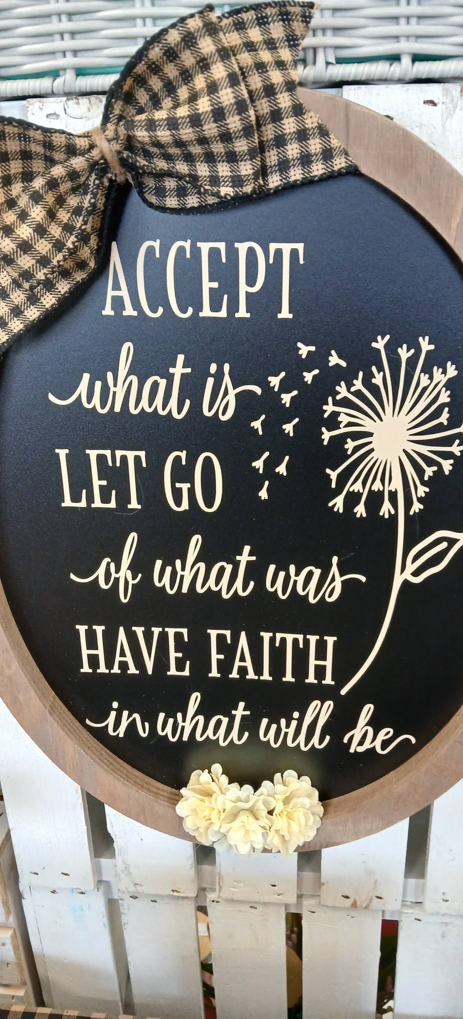 Decorative sign with plaid bow reading “Accept what is, let go of what was, have faith in what will be.”