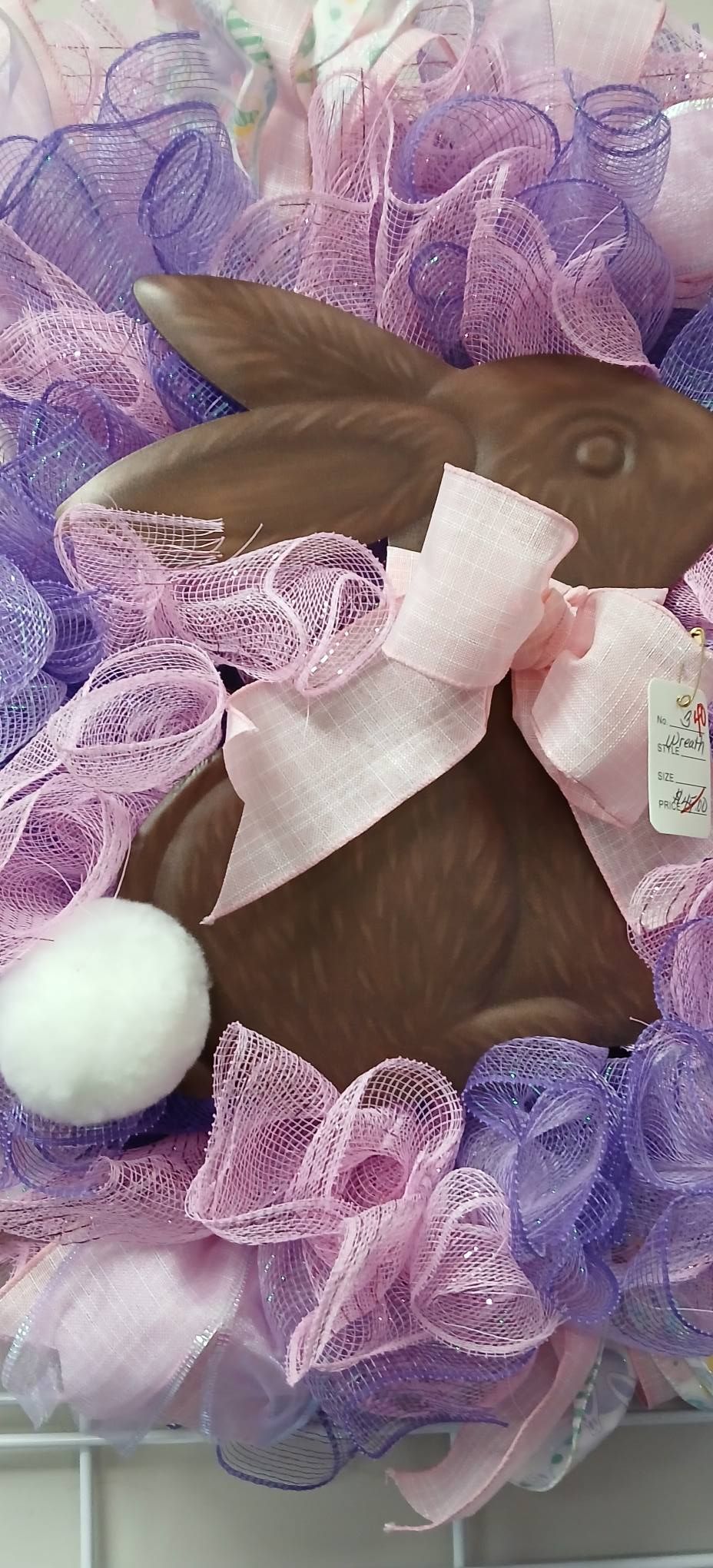 Brown bunny cutout with white bow, surrounded by purple tulle and a white pom-pom