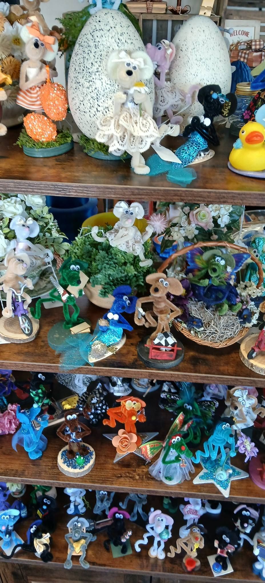 Shelves of colorful ceramic fairy and fantasy figurines on a display in a shop
