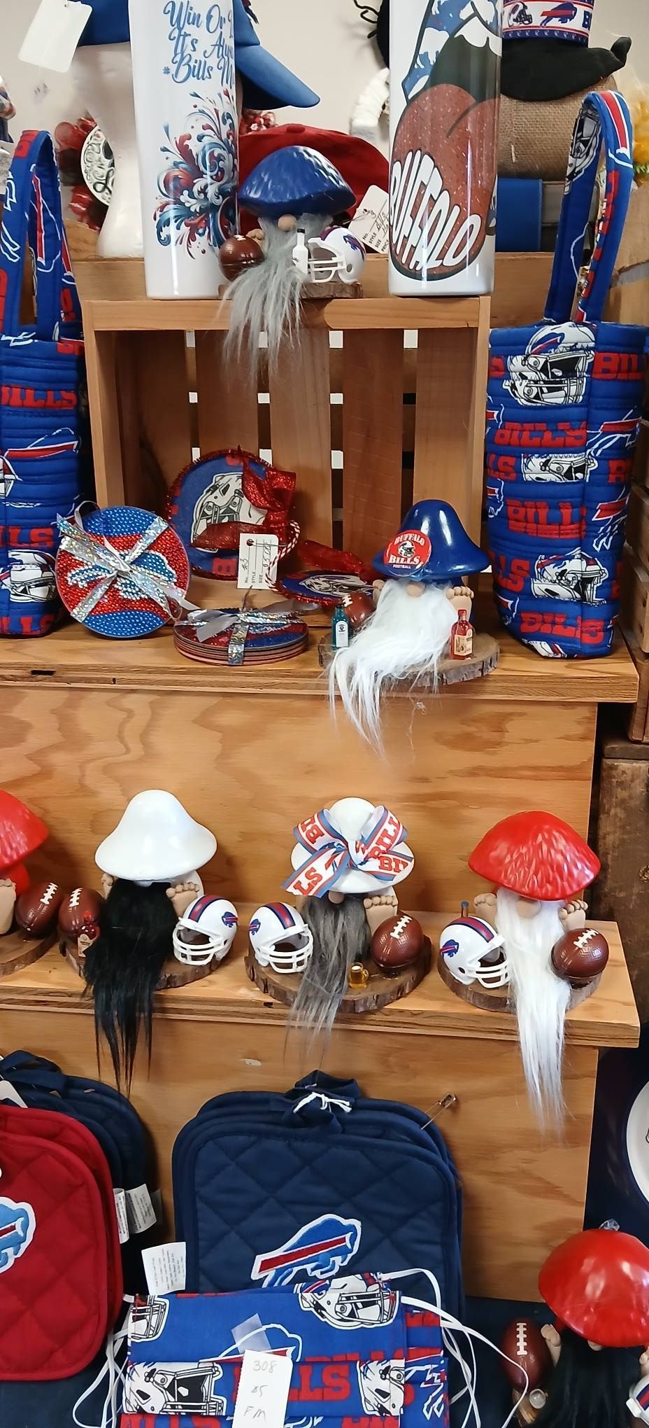 Mushroom-themed display with red, blue, and white decorations on wooden shelves and hanging items