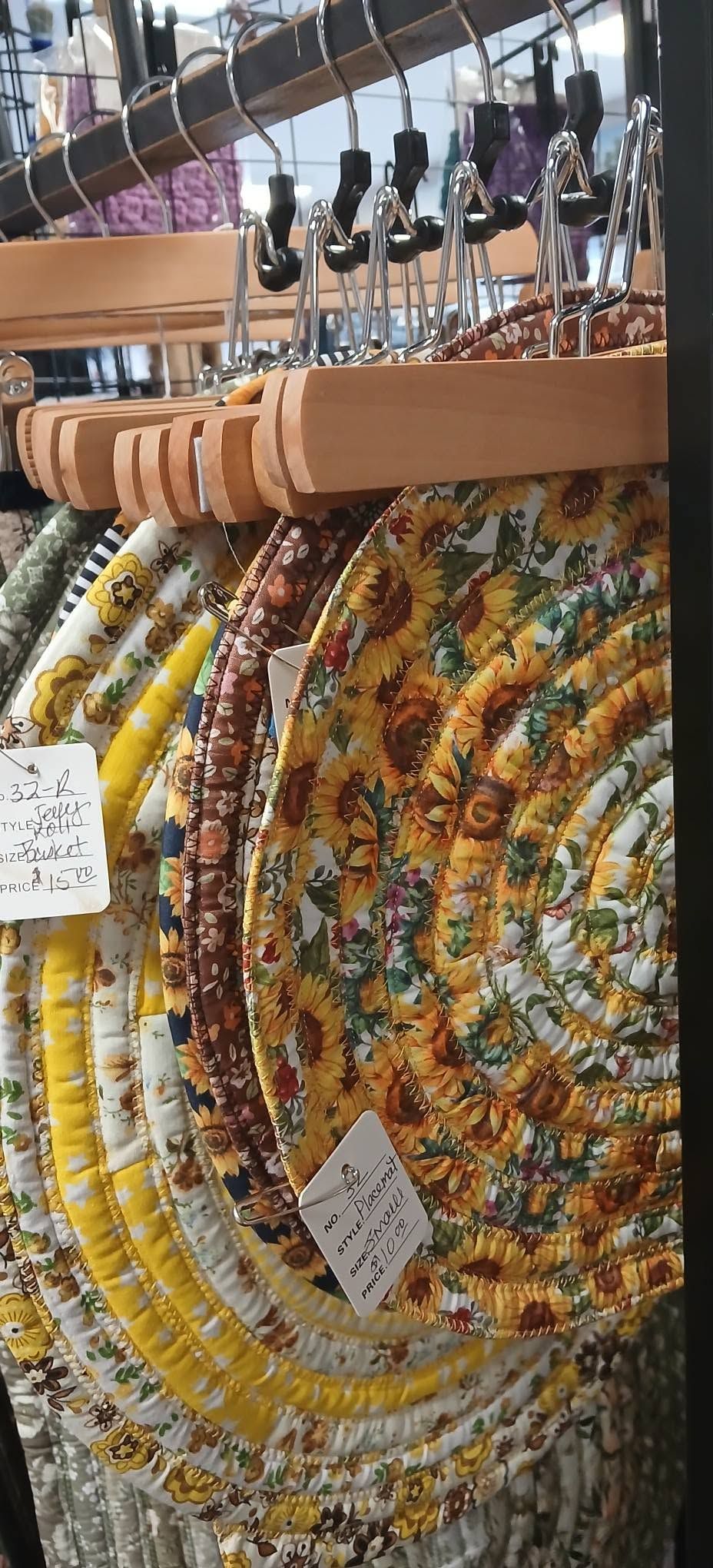 Colorful woven baskets hanging in a market stall, with patterned textiles in the background