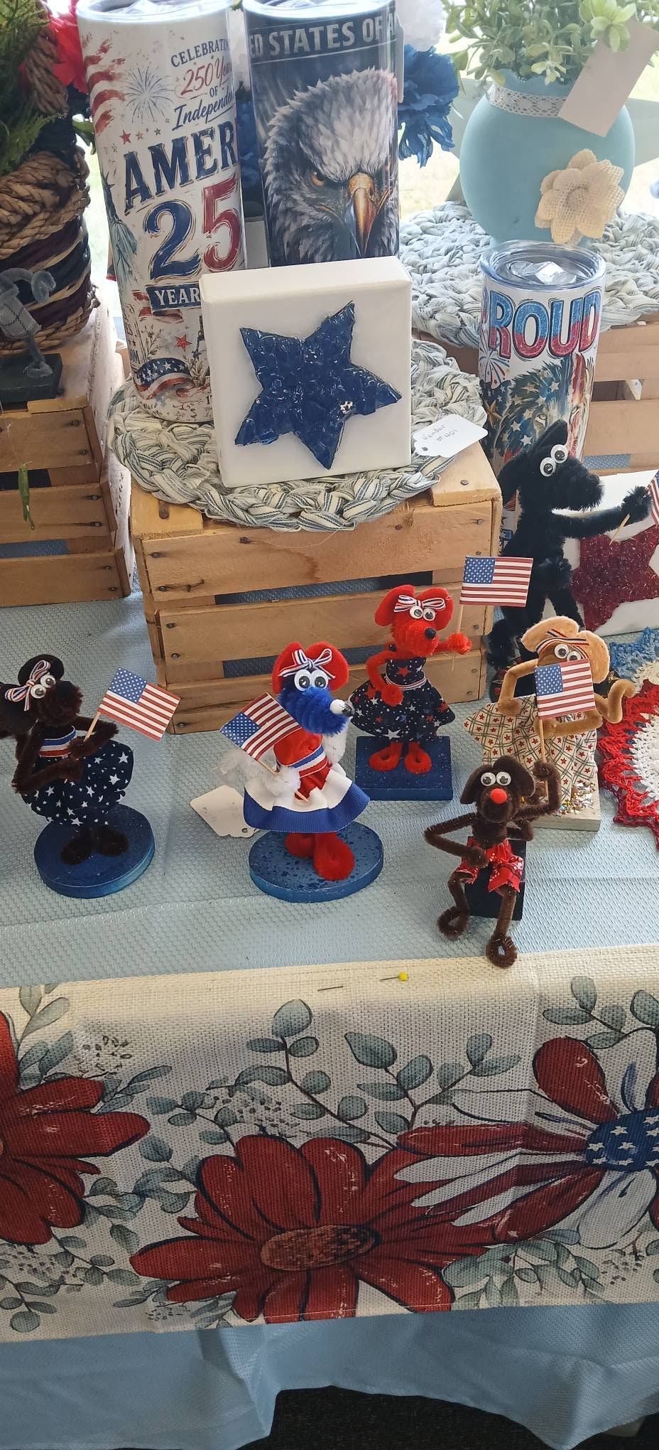 Blue-and-white holiday display with star decor, figurines, and patterned tablecloth.