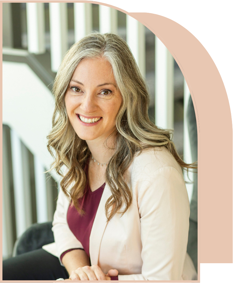 A woman is smiling for the camera while sitting on a chair with a staircase in the background.
