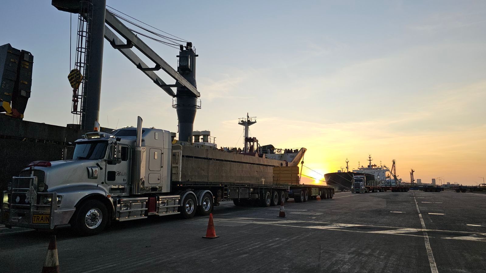A Semi Truck is Parked On The Road With The Sunset In The Background — Harker Haulage In Humpty Doo, NT