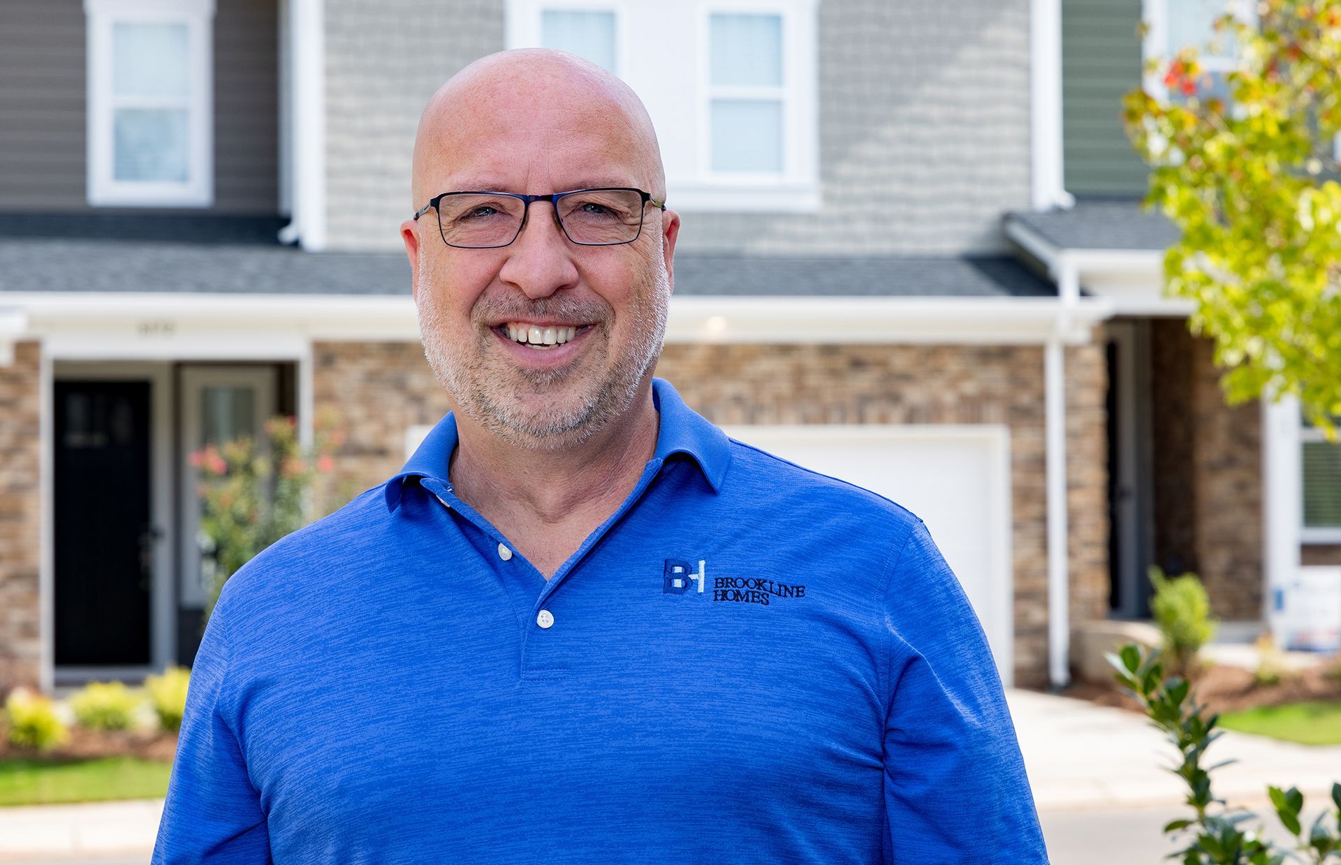 Brett Shippy of Brookline Homes in front of a completed new construction home