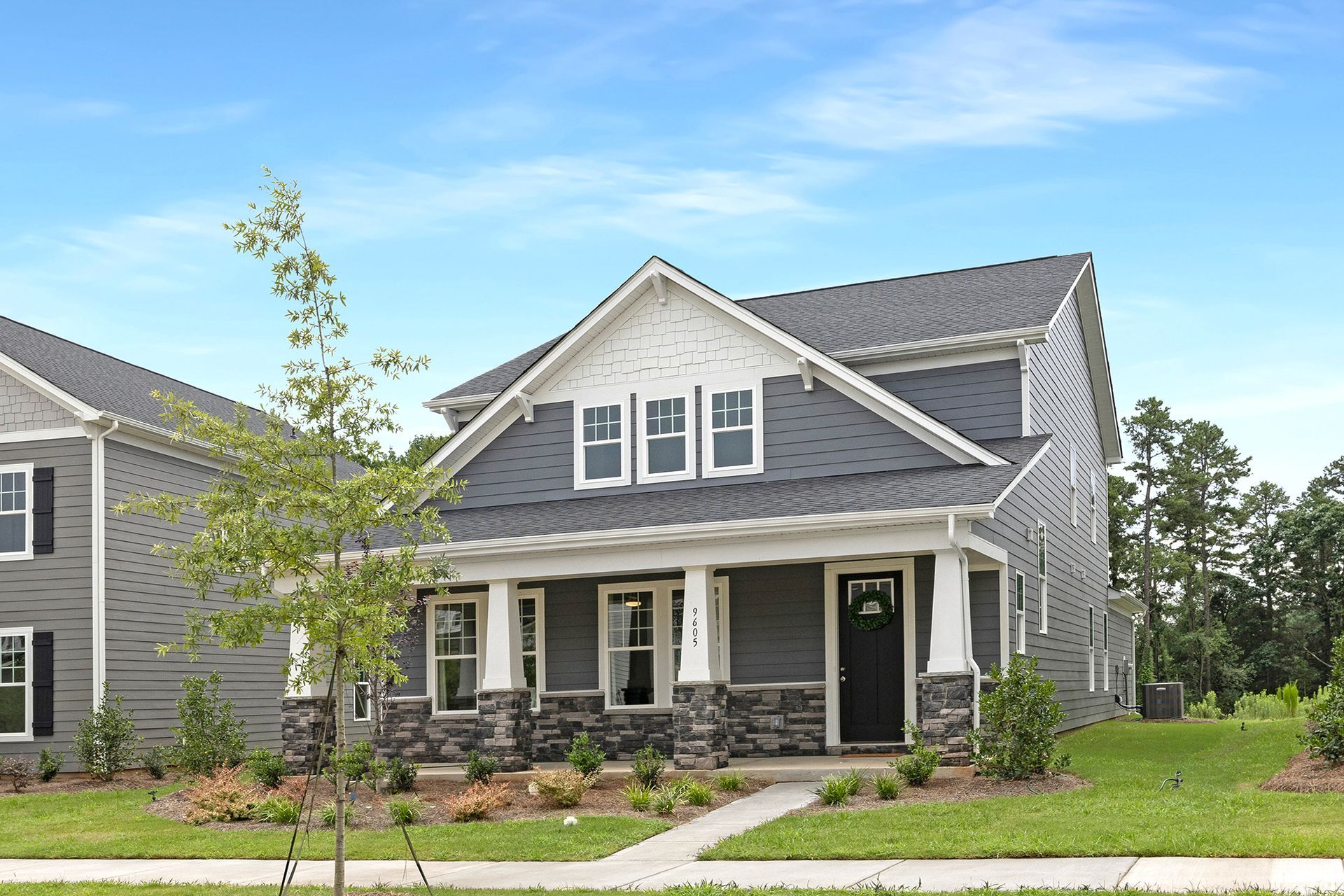 Home in Edgewood Preserve, Huntersville NC built by Brookline Homes with a tree in the front.