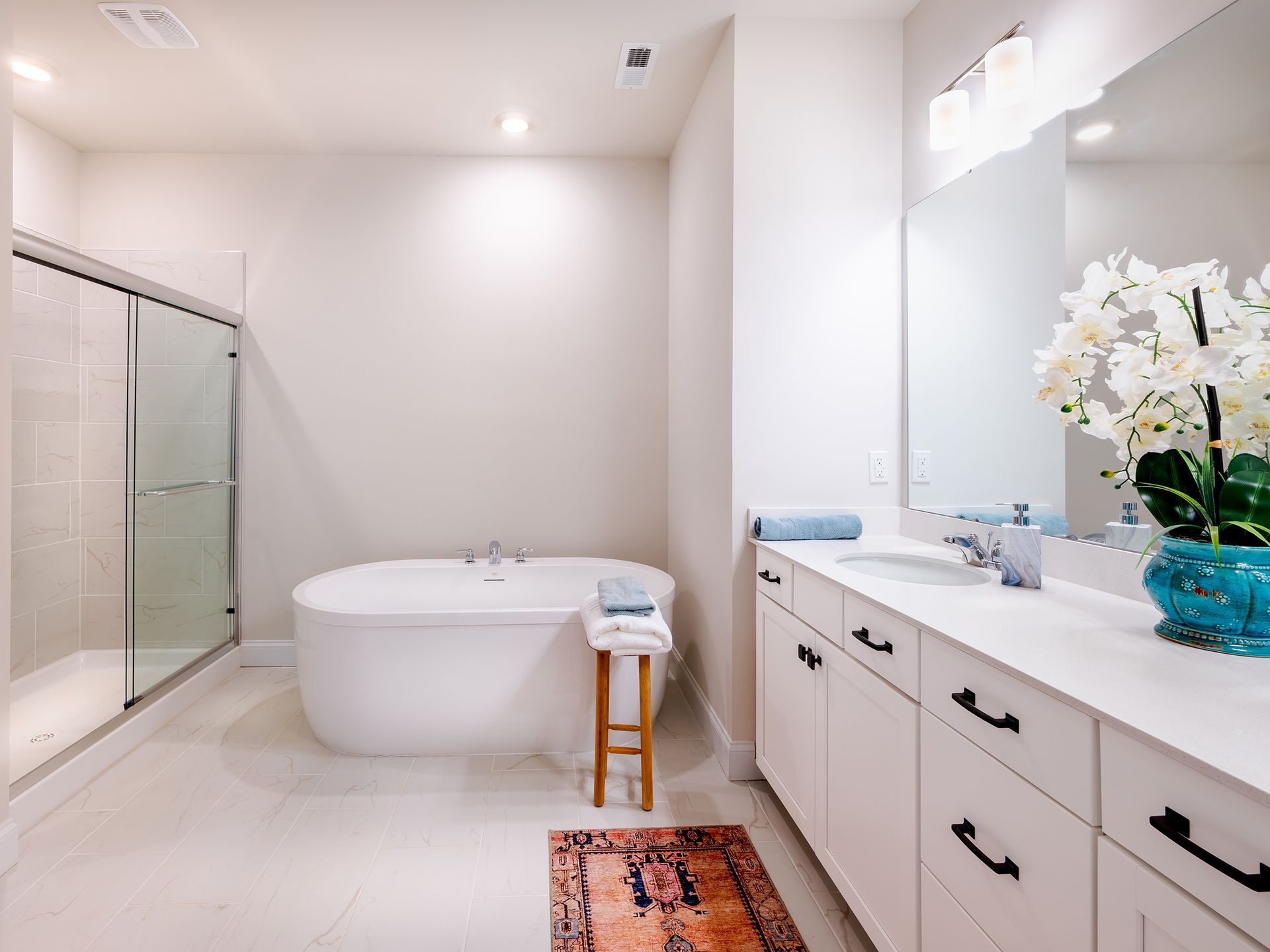 Photo of bathroom with free standing tub and white cabinets