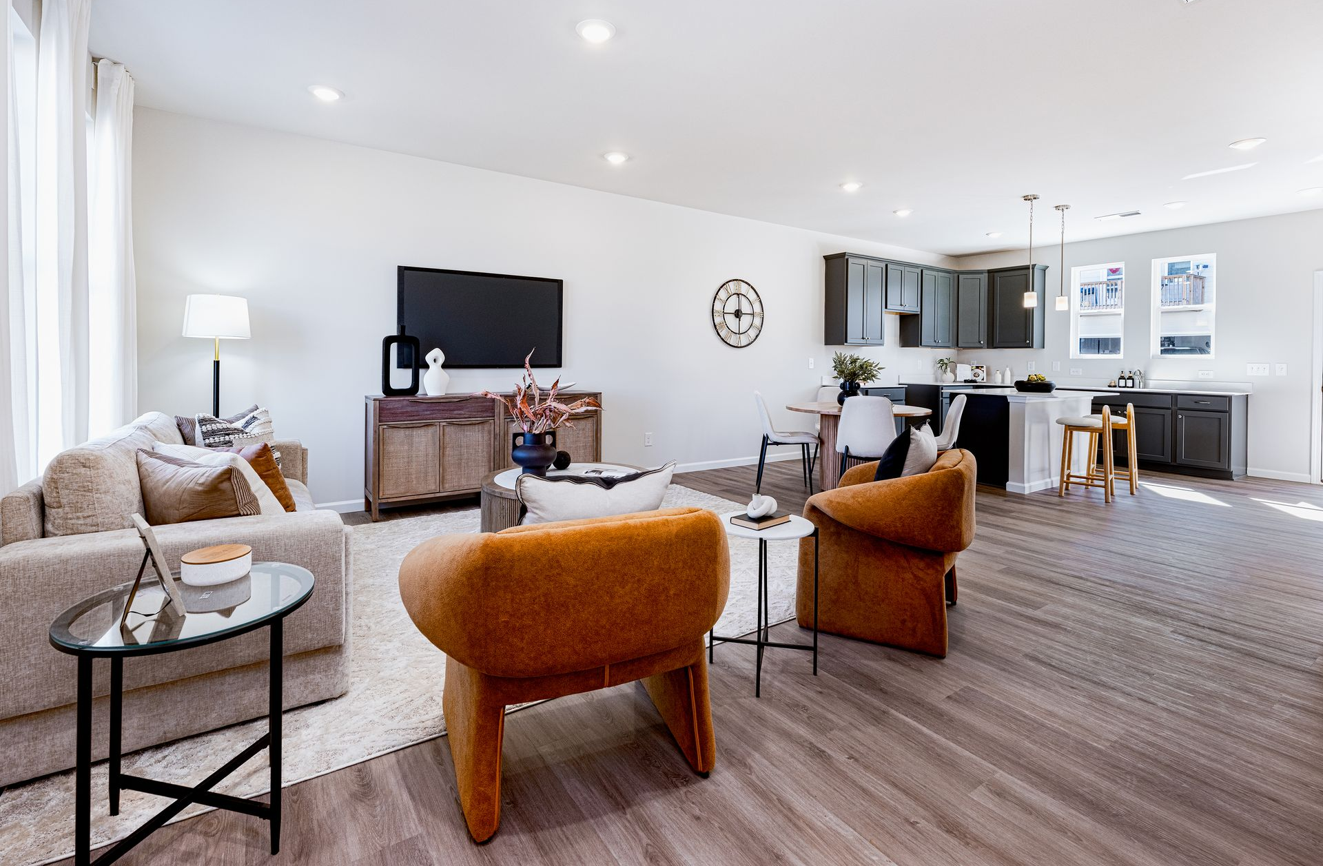 Photo of a staged home living room open to the kitchen