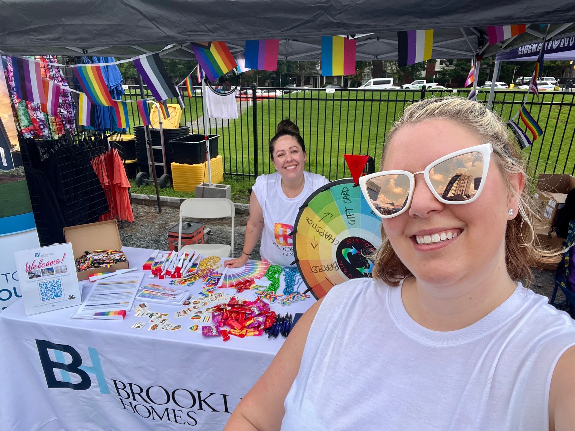 Photo of the Brookline Homes team at the Charlotte Pride event table