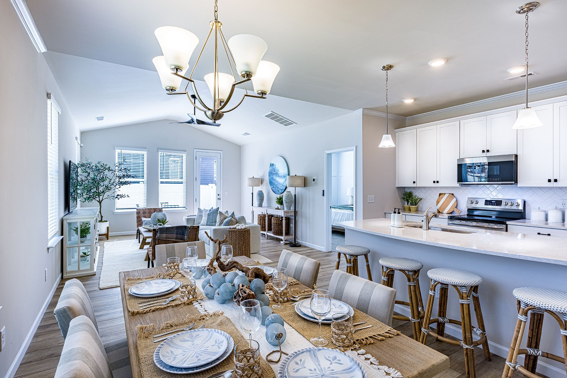 Bright kitchen and living area in a beautiful home, highlighting an open layout with abundant natural sunlight.