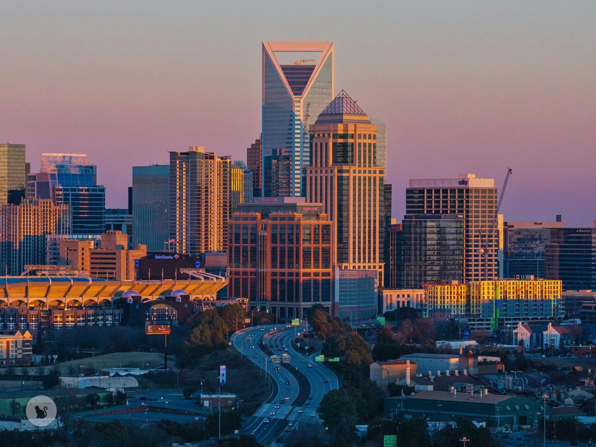 Uptown Charlotte skyline at sunset, illustrating the urban lifestyle pros and cons of buying a home in the city.