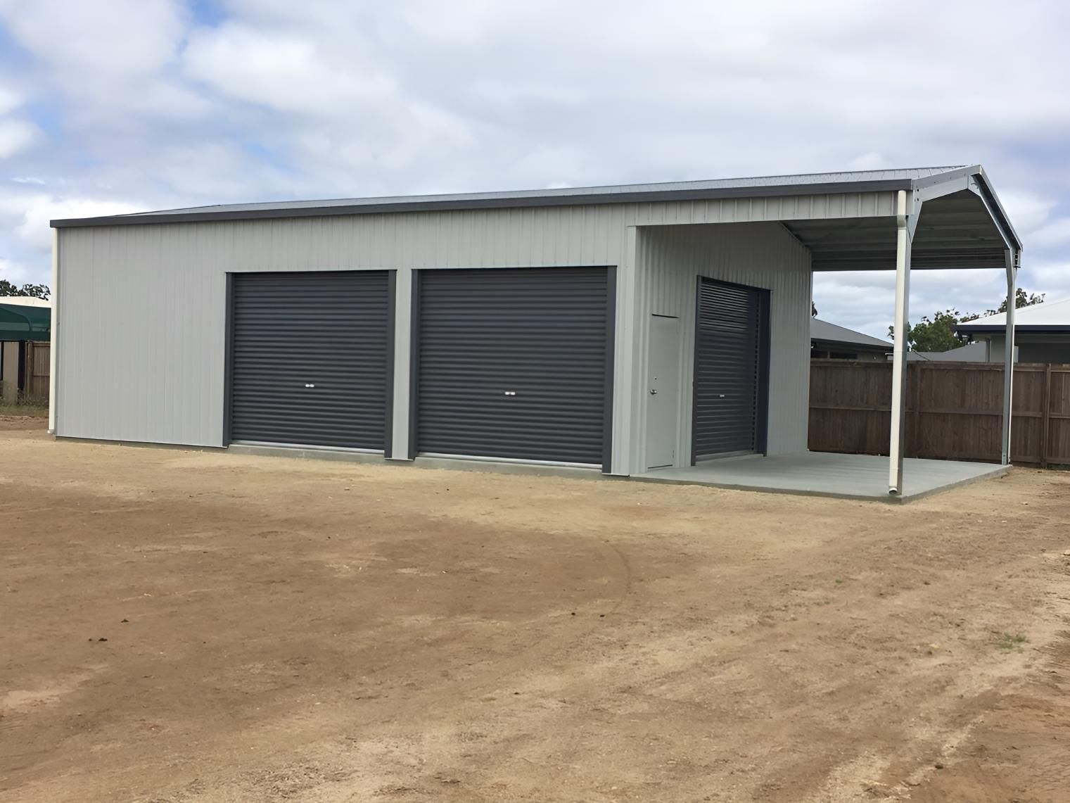 A Garage With Three Garage Doors And A Canopy On Top Of It — Dunnrite Mareeba Sheds & Garages In Mareeba, QLD
