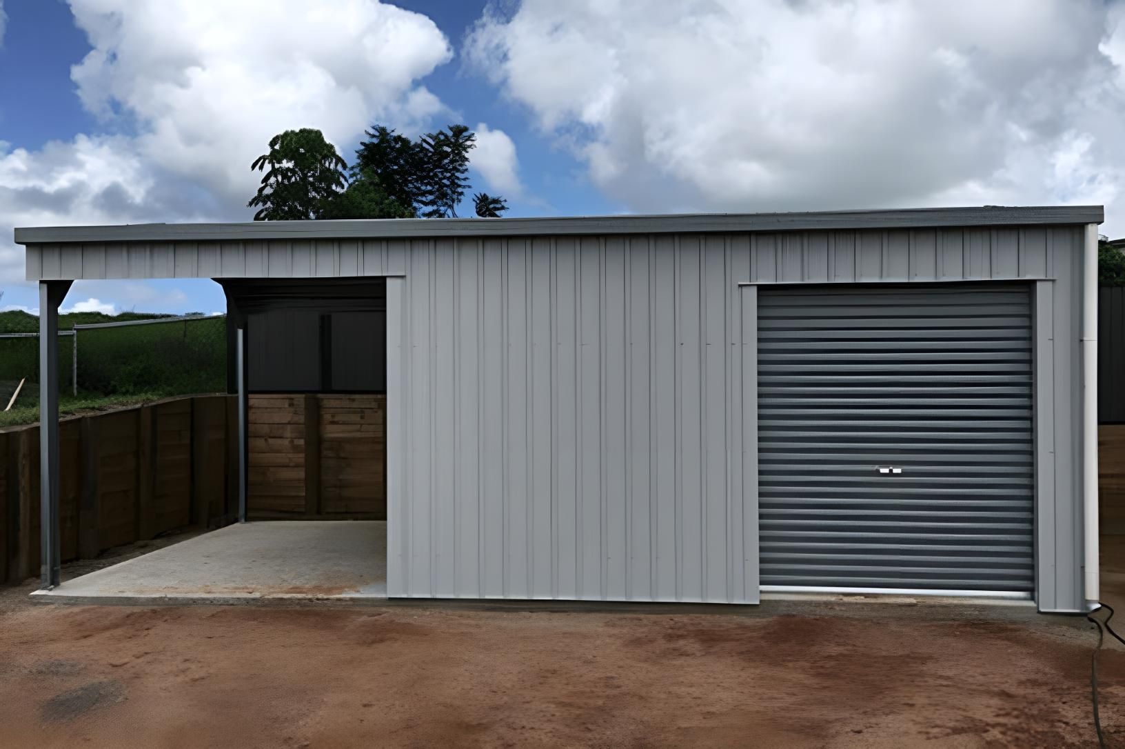 A Shed With A Garage Door And A Fence In The Background — Dunnrite Mareeba Sheds & Garages In Mareeba, QLD
