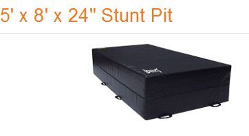 A black 5-foot by 8-foot by 24-inch rectangular stunt pit mat with side handles.