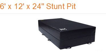 A black rectangular stunt pit mat with the dimensions 6 feet by 12 feet by 24 inches.