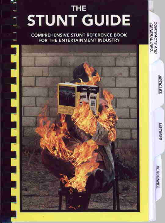 The Stunt Guide, a book cover showing a person engulfed in fire while reading, with yellow borders and tabbed index sides.